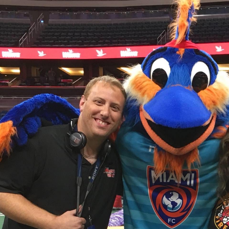 John, Mascot Insider videographer, with a mascot at an event